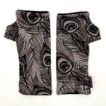 Pacifica Wrist Warmers in black line drawing of peacock feathers on light grey color background  – upcycled fingerless gloves front view