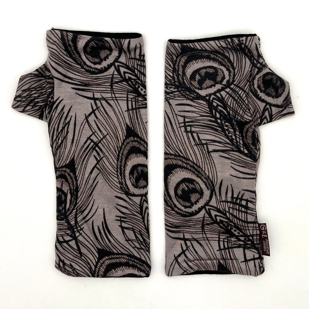 Pacifica Wrist Warmers in black line drawing of peacock feathers on light grey color background  – upcycled fingerless gloves front view