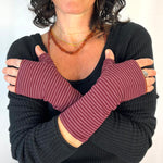 Pacifica Wrist Warmers in red pink white goji berry color way – shown on female model