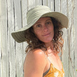 Quito Sun Hat zoomed view of Cactus color, modeled by female highlighting travel-friendly design