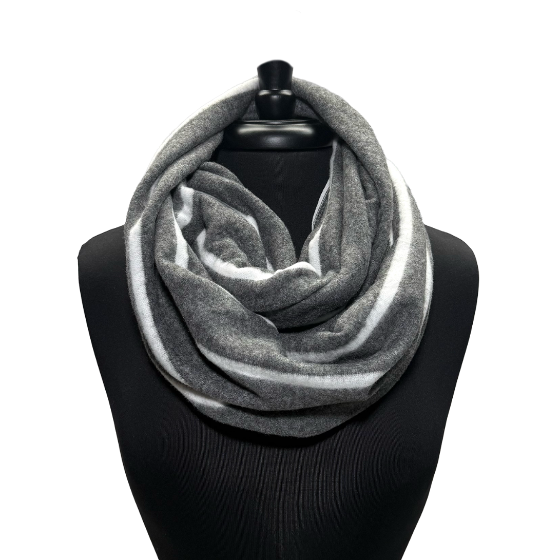 A gray and white striped infinity scarf displayed on a black mannequin torso against a plain white background.