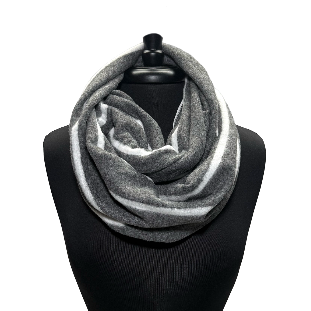 A gray and white striped infinity scarf displayed on a black mannequin torso against a plain white background.