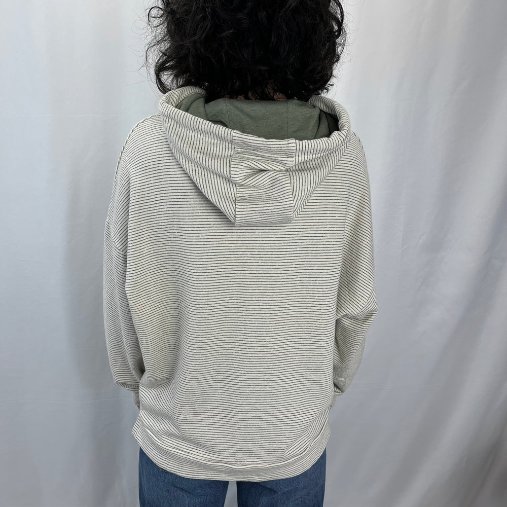 Sea Breeze Hoodie in French Linen – worn by female model showing the back view.