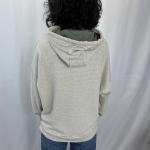 Sea Breeze Hoodie in French Linen – worn by female model showing the back view.