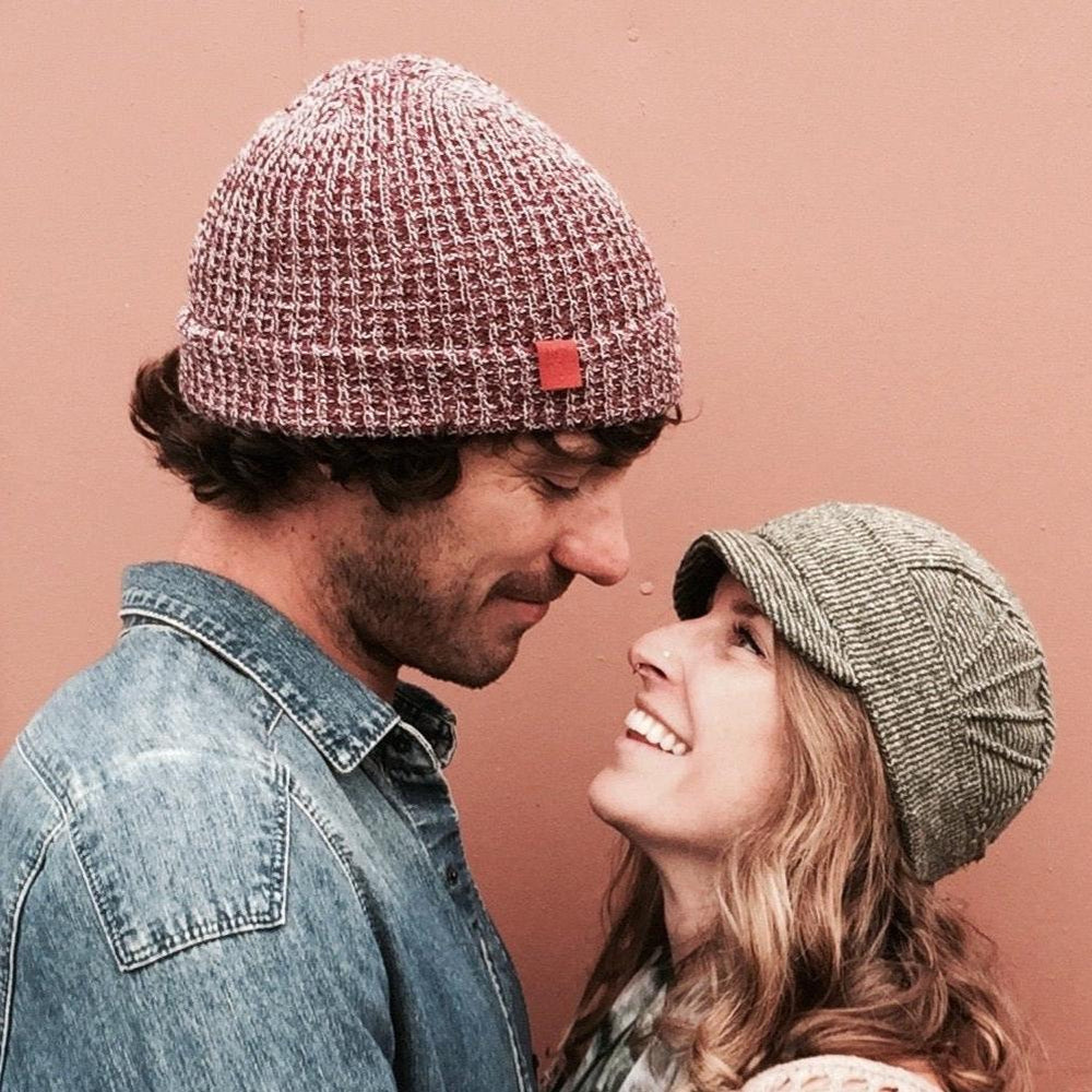 Solstice Soft Cap on female model in green stripe color way looking at male model – USA made recycled cotton hat