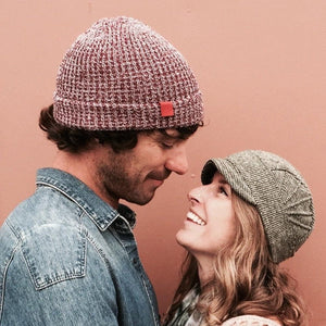 Solstice Soft Cap on female model in green stripe color way looking at male model – USA made recycled cotton hat