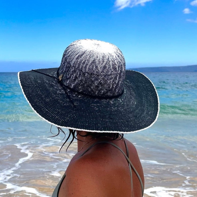 Female model wearing Sonia Sun Hat, back side view zoomed in, with wide brim and coconut button accent