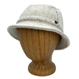 Taylor Bucket Hat in white linen color front view on wooden head block – eco-friendly recycled cotton soft cap