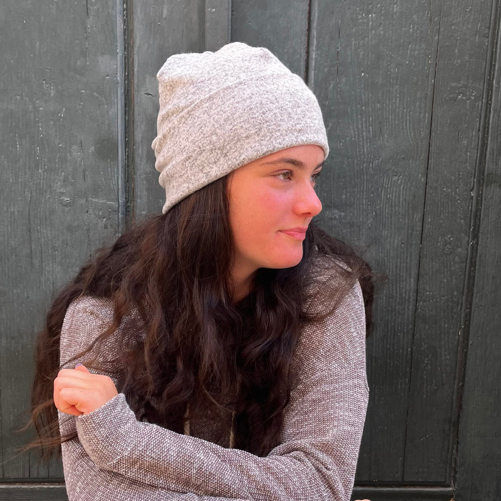 UP Beanie in Snow color way – worn by female model in outdoor setting.