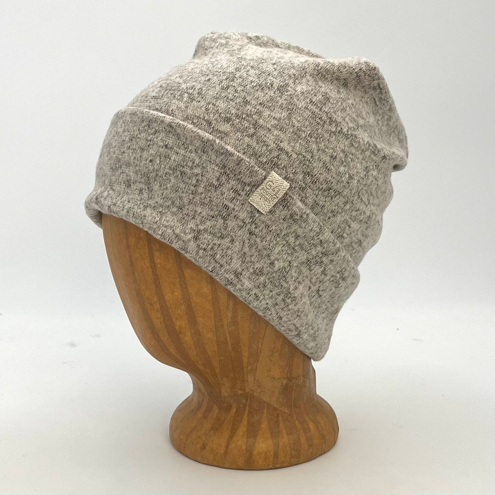 UP Beanie in Snow color – worn on wooden head block.