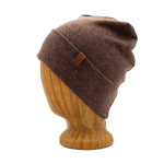 UP Beanie in Wet Sand color – worn on wooden head block.