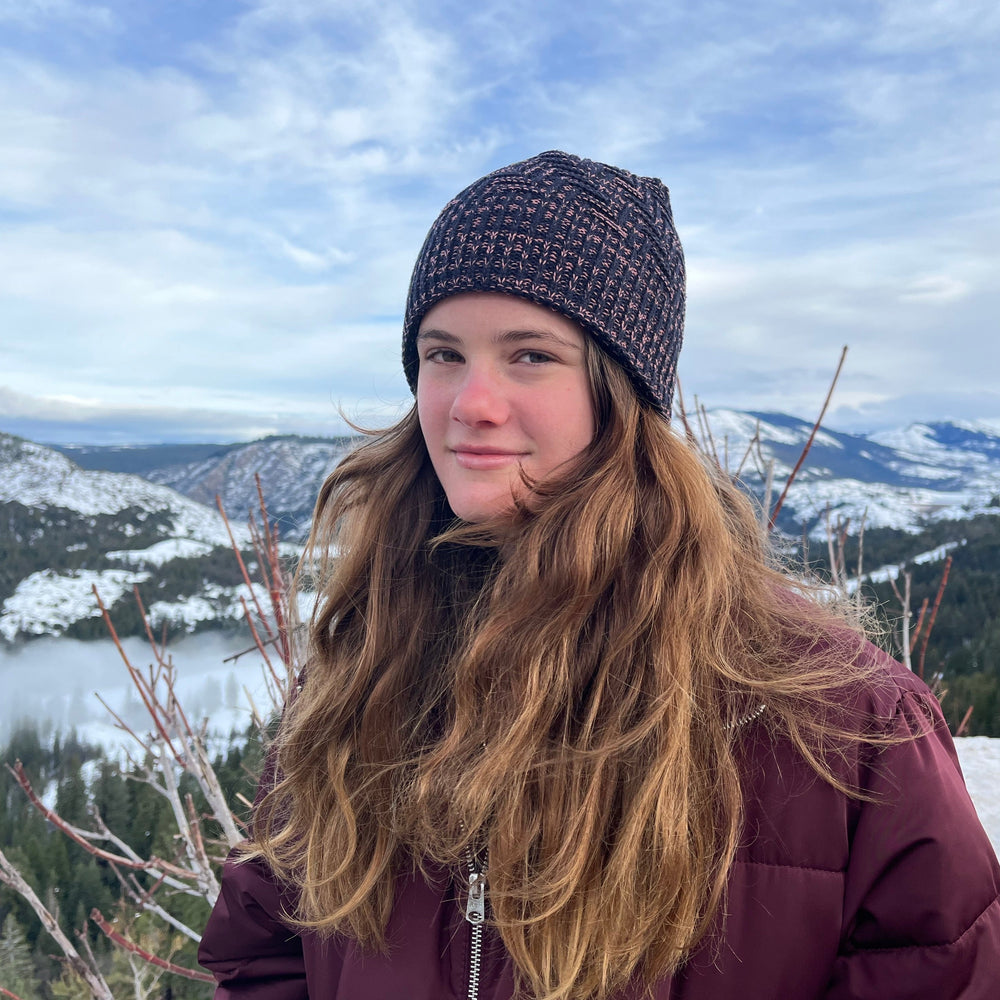 Venice Beanie in Rose Burst color on female model – stylish and sustainable winter headwear