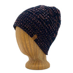 Venice Beanie in Rose Burst color – worn on wooden head block.