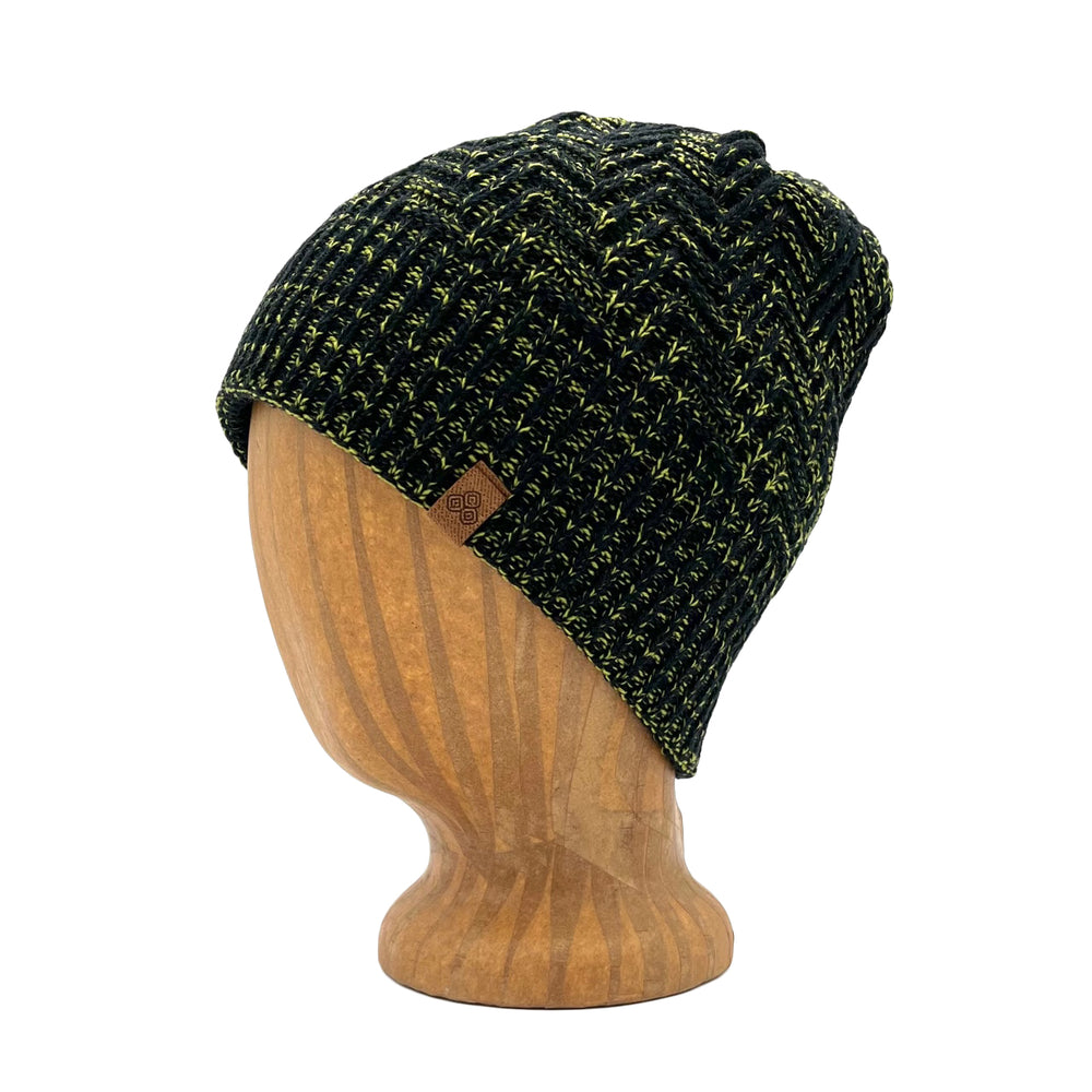 Venice Beanie in Kale color – worn on wooden head block.