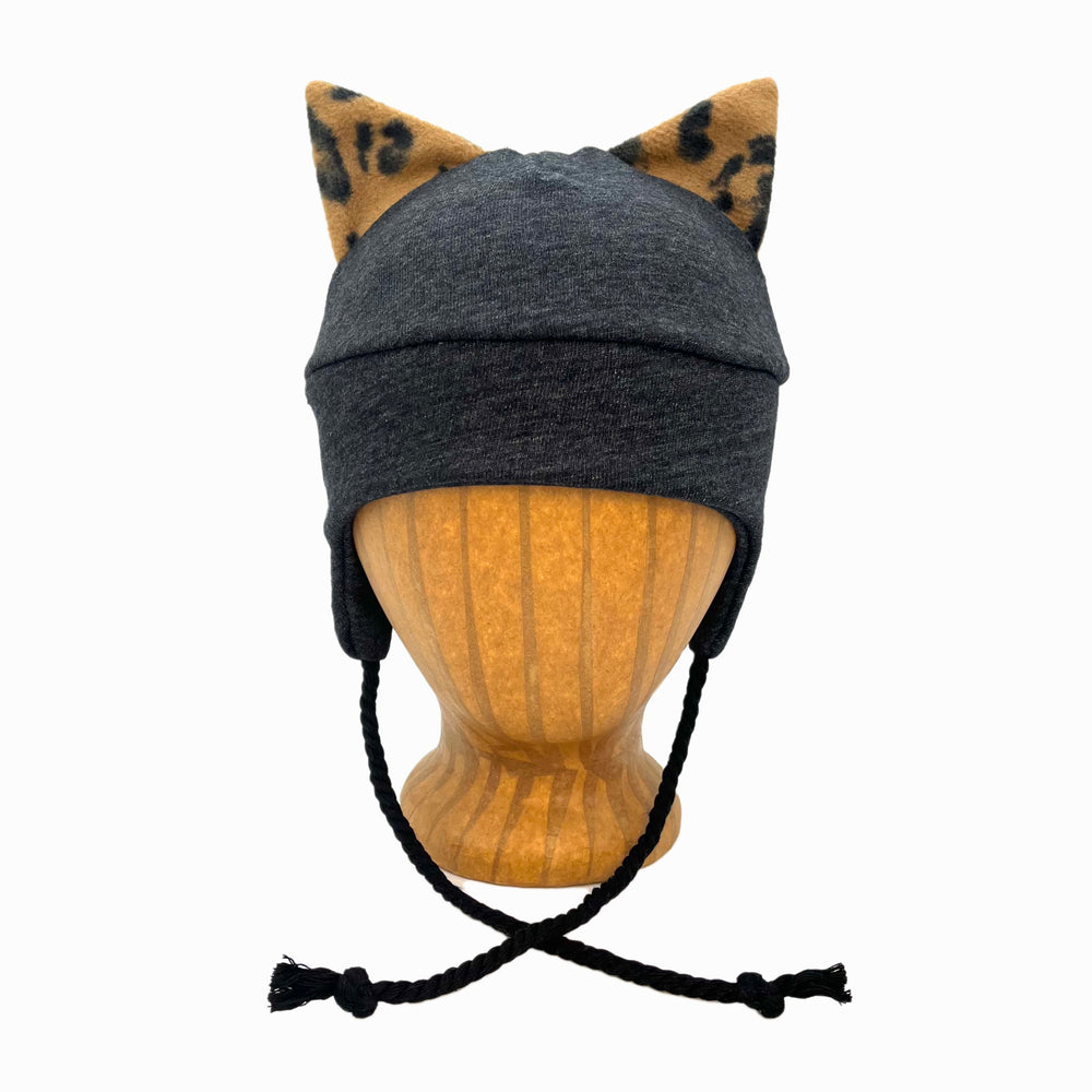 Wildkat Beanie in Black Deep Space color way, front view on wooden head block – fun kids fleece hat with ears by G & L Positive Goods