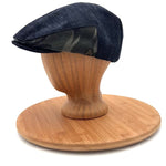 Matisse Flat Cap side view video on mannequin head, upcycled black denim flat cap with camo detail