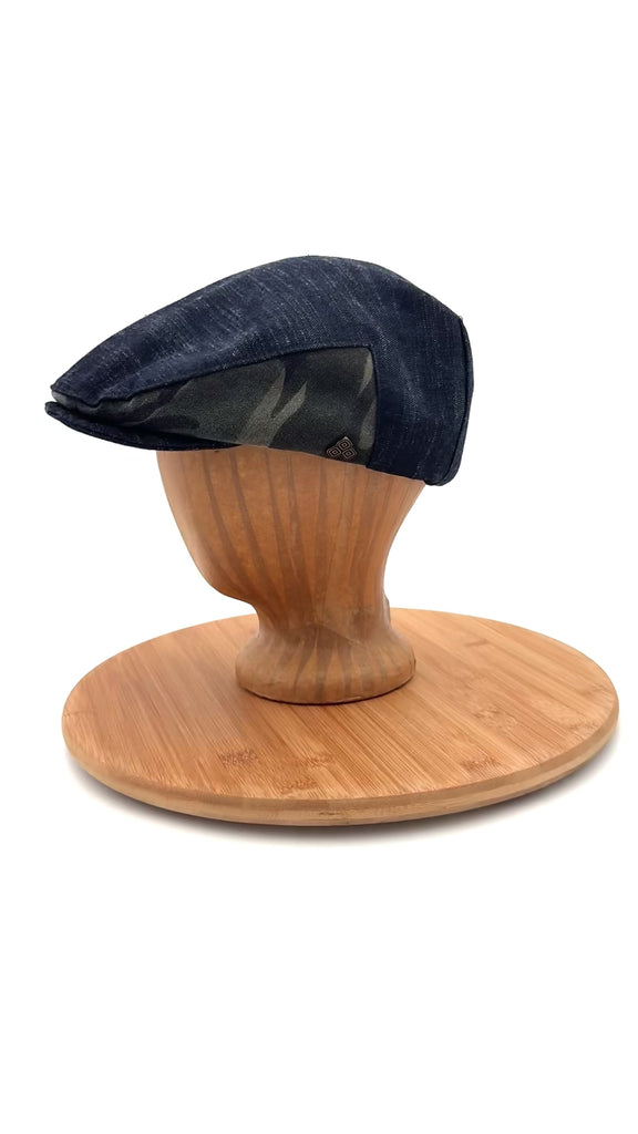 Matisse Flat Cap side view video on mannequin head, upcycled black denim flat cap with camo detail