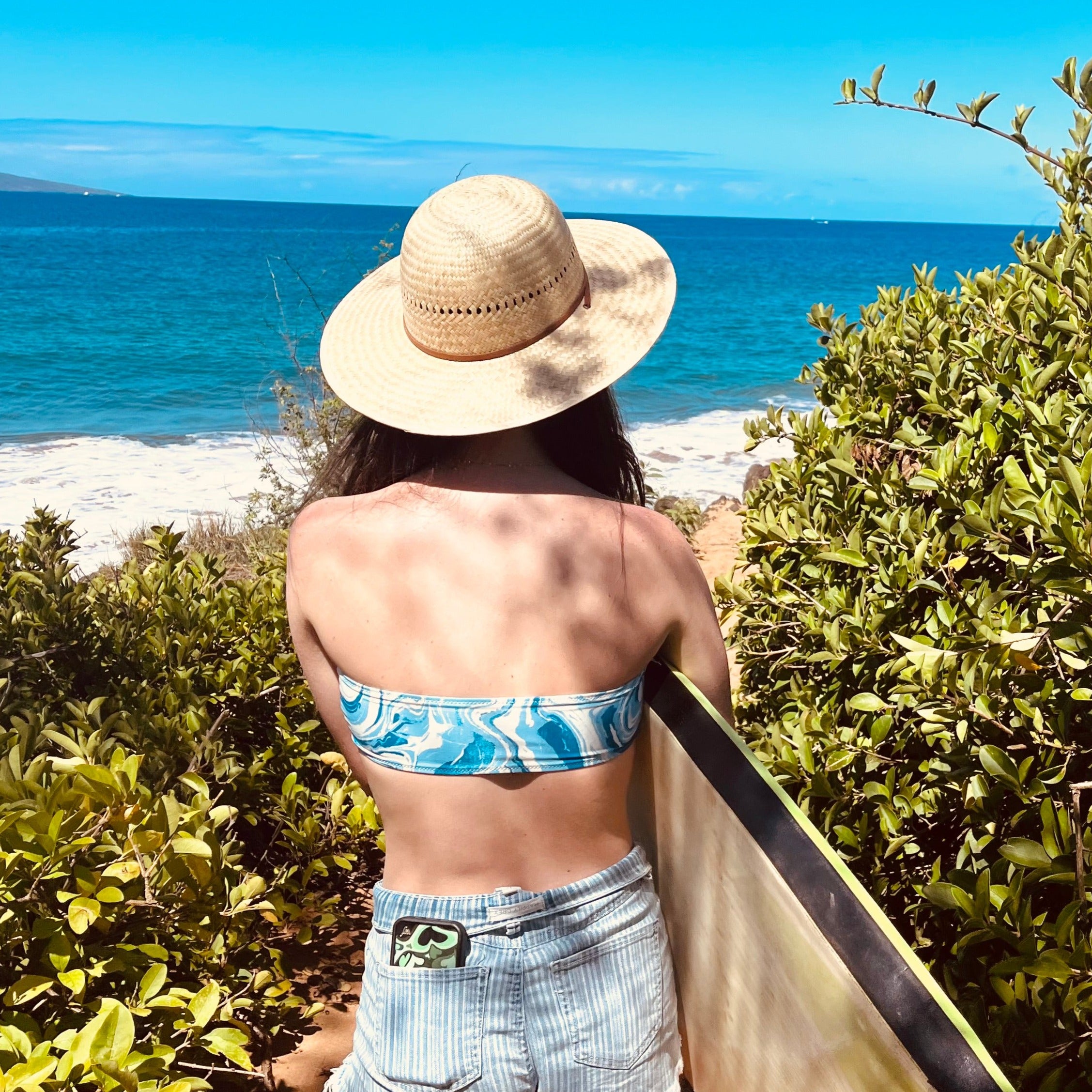 Video showing Hana Palm Straw Sun Hat details including brim, adjustable chin strap, and artisan weave.