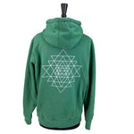 Green zip up hoodie with geometric print on back.