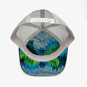 Five-panel low-profile Treetop Trucker Hat. Adjustable mesh back. Faux suede visor. Inspirational quote inside.